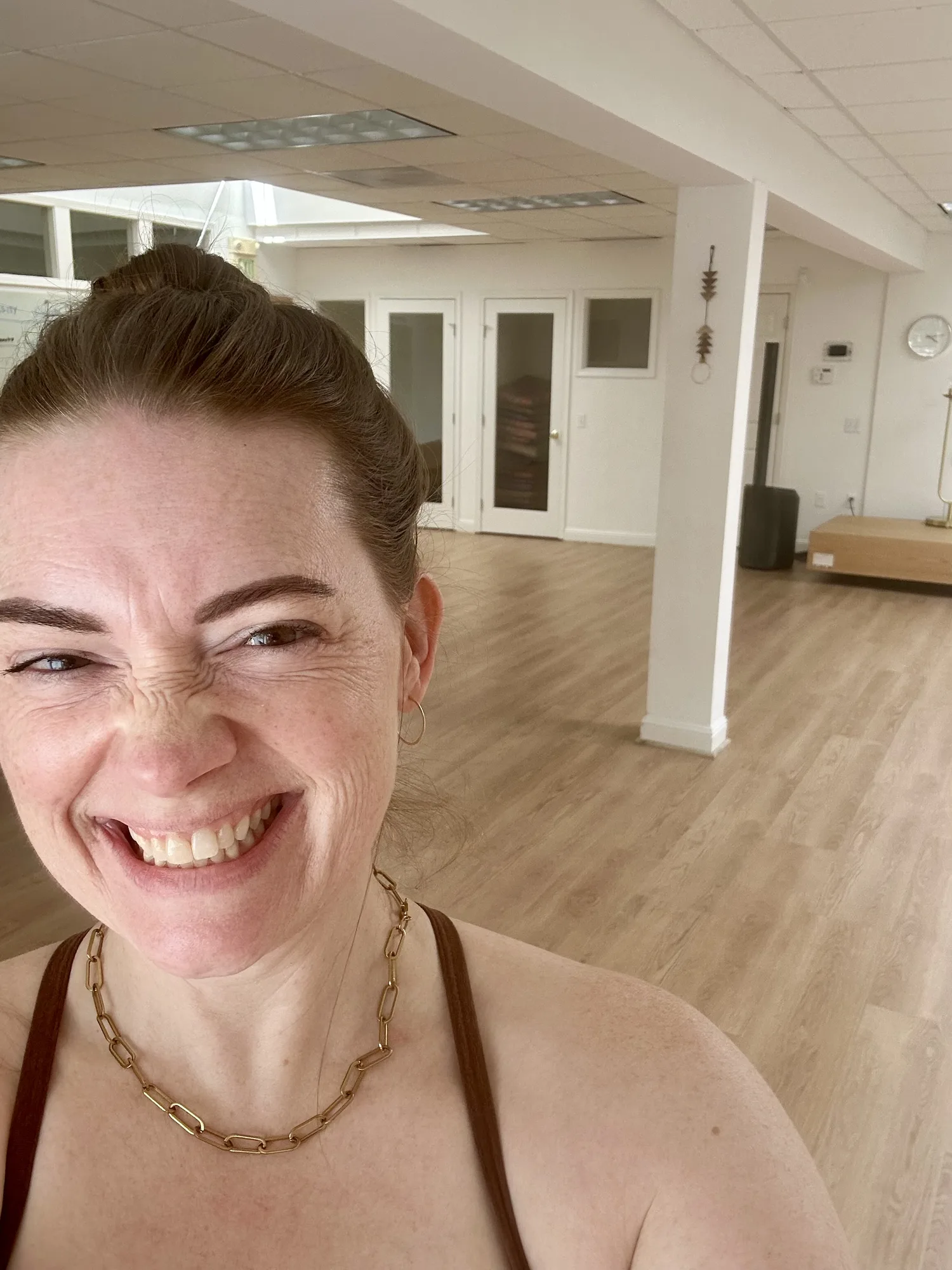 Sara smiling in a yoga studio