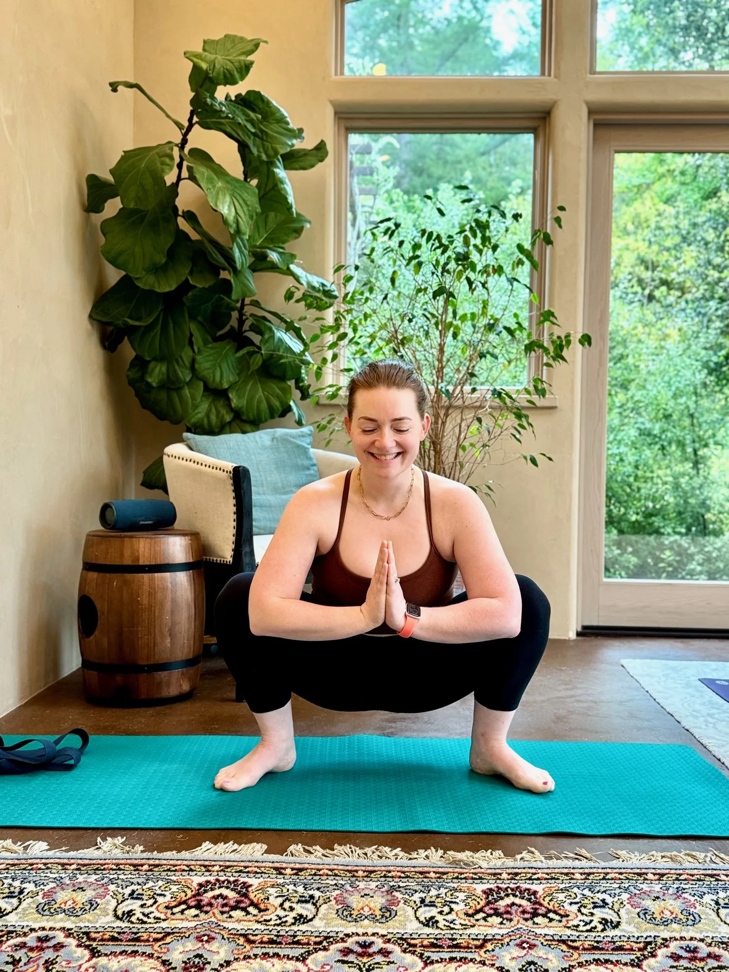 Sara in malasana with prayer hands